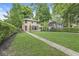 Charming two-story home with manicured lawn and mature trees at 518 Buckingham Dr, Indianapolis, IN 46208