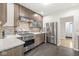 Well-lit kitchen boasts stainless steel appliances, custom cabinetry, and white countertops at 518 Buckingham Dr, Indianapolis, IN 46208