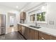 Spacious kitchen includes stainless steel appliances, wooden cabinets, and a bright window over sink at 518 Buckingham Dr, Indianapolis, IN 46208