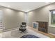 Minimalist interior features a modern chair, hardwood floors, and glass block windows at 518 Buckingham Dr, Indianapolis, IN 46208