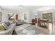 Bright living room showcases modern décor, hardwood floors, and an open floor plan to dining area at 518 Buckingham Dr, Indianapolis, IN 46208