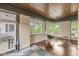 Sunroom featuring hardwood floors, brick walls, wood ceiling, and lots of natural light at 518 Buckingham Dr, Indianapolis, IN 46208
