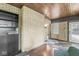 Cozy sunroom with brick walls, wood ceiling, and ample natural light at 518 Buckingham Dr, Indianapolis, IN 46208