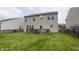 Backyard with a wooden deck and expansive grassy area, ideal for outdoor enjoyment at 5215 Climbing Rose Pl, Indianapolis, IN 46254