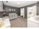 Bedroom with a crib, changing table, and plenty of natural light from two windows at 5215 Climbing Rose Pl, Indianapolis, IN 46254