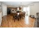 Cozy dining area features a wooden table and chairs, with an adjacent modern kitchen and views of the backyard at 5215 Climbing Rose Pl, Indianapolis, IN 46254