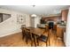 Open concept dining area with laminate floors adjacent to a kitchen featuring granite countertops and stainless steel appliances at 5215 Climbing Rose Pl, Indianapolis, IN 46254
