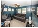 Comfortable living room with a ceiling fan, large windows, and plush seating at 5215 Climbing Rose Pl, Indianapolis, IN 46254