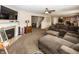 Inviting living room featuring a cozy fireplace, a large sectional sofa, and an open layout that connects to the kitchen at 5215 Climbing Rose Pl, Indianapolis, IN 46254