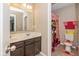 Well-lit bathroom with double sink vanity, ample counter space, a mirror, and a colorful shower curtain at 5767 Bluff View Ln, Whitestown, IN 46075