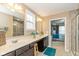 Bathroom with double sinks, tile floor, large mirrors, and a tiled walk-in shower providing elegance and functionality at 5767 Bluff View Ln, Whitestown, IN 46075