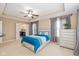 A lovely bedroom featuring a trey ceiling, carpet flooring, a ceiling fan, and an ensuite bathroom entrance at 5767 Bluff View Ln, Whitestown, IN 46075