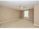 Neutral bedroom with a ceiling fan, carpet flooring, and natural light streaming through the window at 5767 Bluff View Ln, Whitestown, IN 46075
