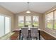 Bright dining room featuring hardwood floors, modern decor, and natural light from multiple windows at 5767 Bluff View Ln, Whitestown, IN 46075