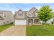 Charming two-story home with stone accents, well-manicured lawn, and an attached two-car garage at 5767 Bluff View Ln, Whitestown, IN 46075
