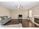 Comfortable living room with a fireplace, ceiling fan, hardwood floors, and plenty of space for Gathering at 5767 Bluff View Ln, Whitestown, IN 46075