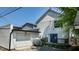 This angle shows the rear of the home, detached garage, blue door to access the wooden deck at 615 Orange St, Indianapolis, IN 46203