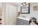 Updated bathroom boasts a modern vanity, a stylish mirror, and a shower with tile surround at 615 Orange St, Indianapolis, IN 46203