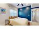 Comfortable bedroom features a ceiling fan, a cozy bed, and a window that lets in natural light at 615 Orange St, Indianapolis, IN 46203