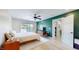 Bright bedroom with a queen bed, ceiling fan, and an en-suite door entrance at 615 Orange St, Indianapolis, IN 46203