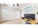 Well-lit bedroom with a ceiling fan, a spacious closet, and a functional desk setup for work or study at 615 Orange St, Indianapolis, IN 46203