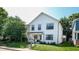 A modern two-story home with white siding, black trim, and a well-manicured lawn at 615 Orange St, Indianapolis, IN 46203
