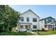 Charming two-story home featuring white siding, a welcoming front porch, and well-maintained landscaping at 615 Orange St, Indianapolis, IN 46203