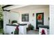 A charming front porch with white brick pillars, outdoor seating, and plants next to the front door at 615 Orange St, Indianapolis, IN 46203