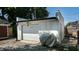 A detached single-car garage with a covered grill in a gravel backyard at 615 Orange St, Indianapolis, IN 46203