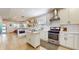 Open concept kitchen with stainless steel appliances, white cabinets, and an island at 615 Orange St, Indianapolis, IN 46203