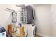 A modern laundry room with a stacked washer and dryer and a wooden drying rack on the wall at 615 Orange St, Indianapolis, IN 46203