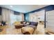 Comfortable living room with a stylish sectional sofa, blue accent wall, and bright natural light at 615 Orange St, Indianapolis, IN 46203