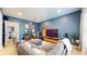 Inviting living room with a sectional sofa, blue accent wall, TV, and modern decor at 615 Orange St, Indianapolis, IN 46203