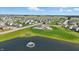 Aerial of community featuring houses, a pool, playground, pond, and green common areas on a bright day at 6762 Brentwood Ct, Brownsburg, IN 46112