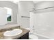 A bathroom featuring a dark vanity with a light countertop, a sink, toilet, and shower/tub combination at 6762 Brentwood Ct, Brownsburg, IN 46112