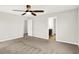 A bedroom with neutral carpet, an open doorway to a bathroom, and a fan at 6762 Brentwood Ct, Brownsburg, IN 46112