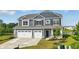 Charming two-story home with three-car garage, showcasing classic design and curb appeal at 6762 Brentwood Ct, Brownsburg, IN 46112