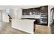 Well-lit kitchen featuring dark cabinets, stainless steel appliances, and large center island at 6762 Brentwood Ct, Brownsburg, IN 46112