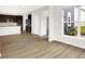 Spacious living room showcasing hardwood floors and an open layout to the kitchen at 6762 Brentwood Ct, Brownsburg, IN 46112