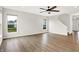 Living room with hardwood floors, recessed lighting and backyard views through two windows at 6762 Brentwood Ct, Brownsburg, IN 46112