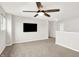 Open living room with neutral carpet, ceiling fan, and television at 6762 Brentwood Ct, Brownsburg, IN 46112
