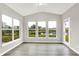 Bright living room boasts hardwood floors and several windows with scenic backyard views at 6762 Brentwood Ct, Brownsburg, IN 46112