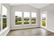 Bright living room features hardwood floors, multiple windows and a glass paneled door at 6762 Brentwood Ct, Brownsburg, IN 46112