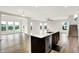 Spacious living room with hardwood floors, large windows, and view of a beautiful pond at 6762 Brentwood Ct, Brownsburg, IN 46112