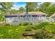 Expansive backyard featuring a well-maintained lawn, a deck, and mature trees at 6933 Grey Wolf Dr, , IN 46164