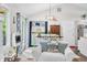 Bright dining area with natural light, white chairs, and views of the kitchen and living room at 6933 Grey Wolf Dr, , IN 46164