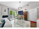 Cozy dining area with a wood table, white chairs, sliding door and modern light fixture at 6933 Grey Wolf Dr, , IN 46164