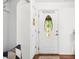 Elegant front door features decorative glass, enhancing the home's inviting entryway with white trim and hardwood floors at 6933 Grey Wolf Dr, , IN 46164