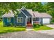 Charming blue home with a welcoming front porch and well-maintained landscaping in a wooded location at 6933 Grey Wolf Dr, , IN 46164