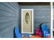 Front porch with a patterned screen door and colorful outdoor chairs at 6933 Grey Wolf Dr, , IN 46164